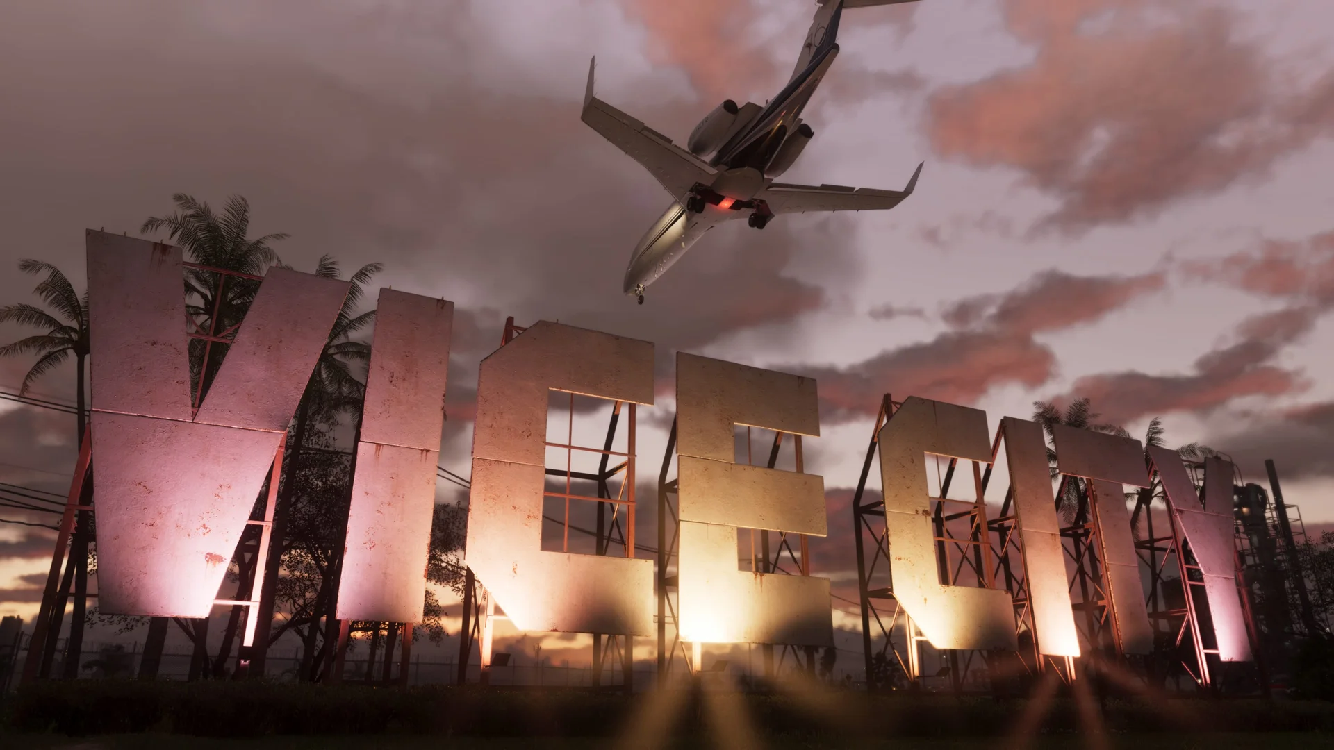 A passenger jet flies above the illuminated Vice City sign at sunset